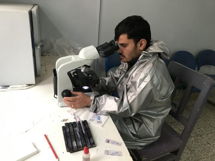 Afghan laboratory technician carrying out diagnostics of TB.