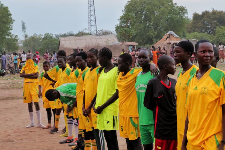 Girls line up ahead of their football match against another local girls team