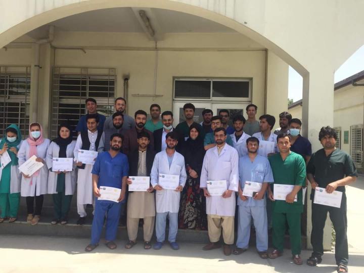 Dr Freba Azizi (middle) and the medical team stand outside the Afghan Japan Hospital in Kabul.