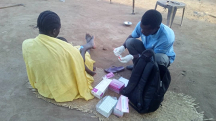 South Sudanese doctor helping out a patient with medical aid