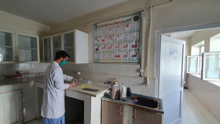 Afghan lab technician performed microscopic examination for tuberculosis