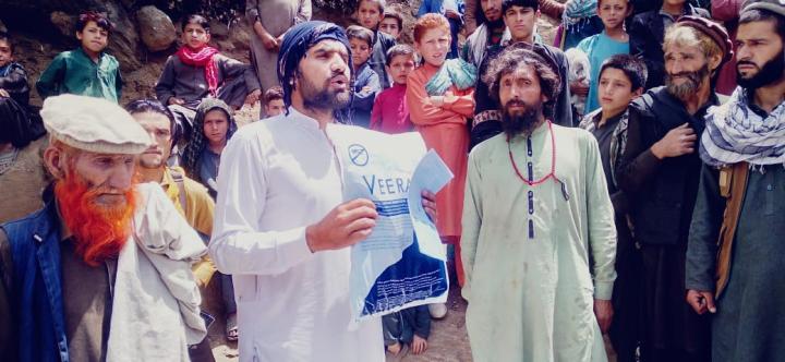 Afghan men standing together, raising awareness